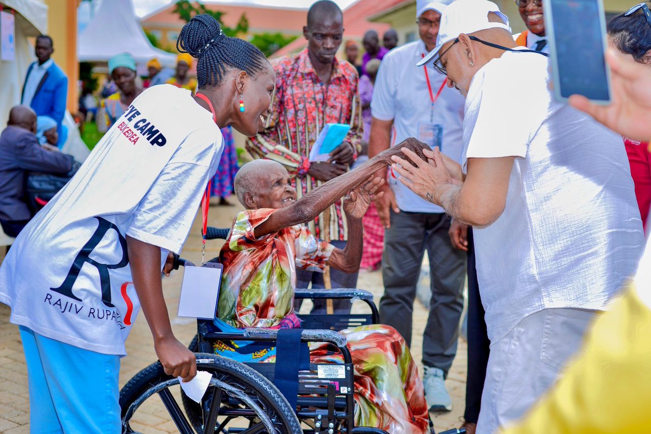Sudhir Ruparelia Gifts Wheelchair to 104-Year-Old Esther Amoding at Rajiv Memorial Eye Camp in Bukedea